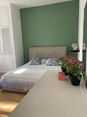 a bedroom with a bed and a table with flowers at Terracito! in Rome