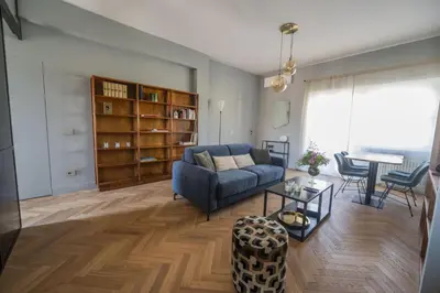 a living room with a blue couch and a table at Terrace Apartment Monte del Gallo by St Peter in Rome