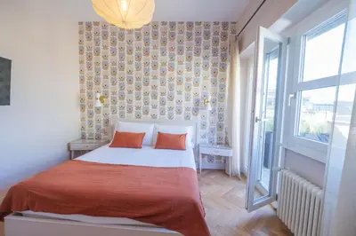 a bedroom with a bed with two orange pillows at Terrace Apartment Monte del Gallo by St Peter in Rome