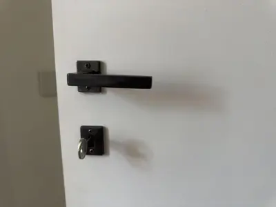 a white door with a black door knob and a door at Terrace Apartment Monte del Gallo by St Peter in Rome