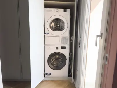 a washer and dryer in a laundry room at Terrace Apartment Monte del Gallo by St Peter in Rome