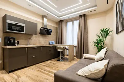 a living room with a couch and a kitchen at Paci Luxury Suite in Rome
