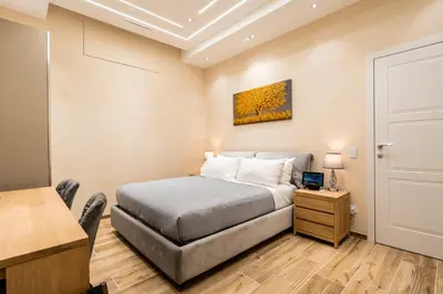 a small bedroom with a bed and a table at Paci Luxury Suite in Rome
