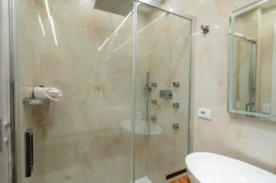 a shower with a glass door in a bathroom at Paci Luxury Suite in Rome