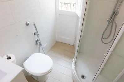 a white bathroom with a toilet and a shower at Vatican Apartment 2 minuti da città del vaticano in Rome