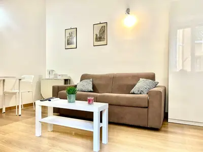 a living room with a couch and a table at Vatican Apartment 2 minuti da città del vaticano in Rome