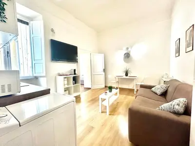 a living room with a couch and a tv at Vatican Apartment 2 minuti da città del vaticano in Rome