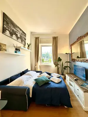 a bedroom with a large bed and a mirror at Vacanze Romane Basilica in Rome
