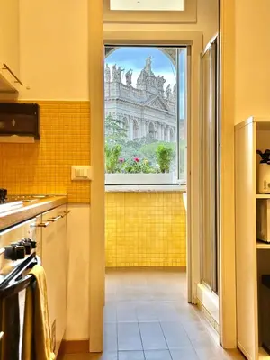 a kitchen with a window with a view of a building at Vacanze Romane Basilica in Rome