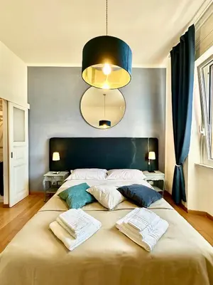 a bedroom with a large bed with two towels on it at Vacanze Romane Basilica in Rome