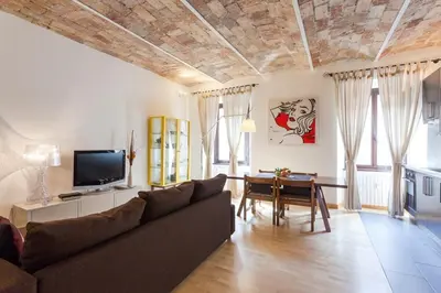 a living room with a couch and a table at Roma Pizza & Mandolino in Rome