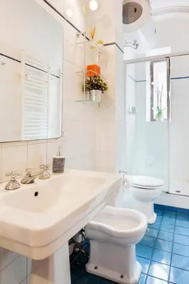 a white bathroom with a sink and a toilet at Roma Pizza & Mandolino in Rome