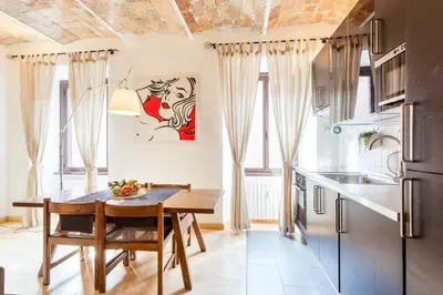 a kitchen with a wooden table and a dining room at Roma Pizza & Mandolino in Rome