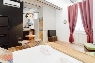 a bedroom with a bed and a table and a television at Monti Urban Studio by Valentina's Dream in Rome