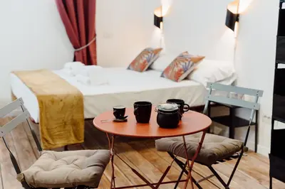a room with a table with two chairs and a bed at Monti Urban Studio by Valentina's Dream in Rome
