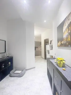 a large white room with a kitchen with a counter at Asia Guest House in Rome