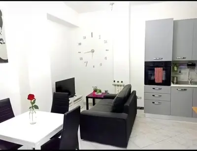 a living room with a black couch and a table at Asia Guest House in Rome