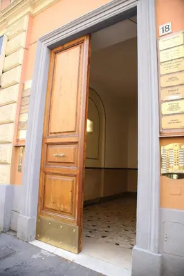 a wooden door in the entry to a building at Emma and Livia's Vatican Suite 1 in Rome