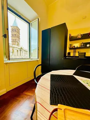 a room with a bed and a large window at Santa Maria Maggiore Suites Apartments in Rome
