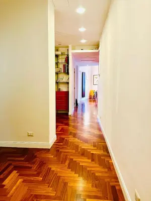an empty hallway with wooden floors and white walls at Santa Maria Maggiore Suites Apartments in Rome