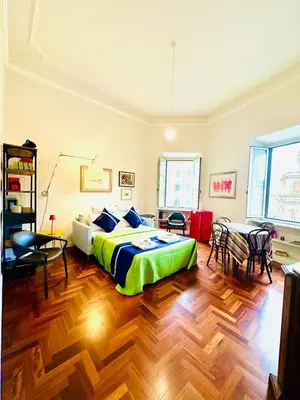 a bedroom with a bed and a table and chairs at Santa Maria Maggiore Suites Apartments in Rome