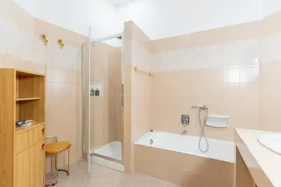 a bathroom with a tub and a shower and a sink at Maison Villa Borghese in Rome