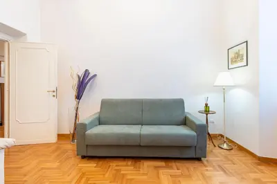 a blue couch sitting in a living room at Maison Villa Borghese in Rome