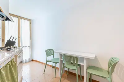 a kitchen with two chairs and a counter with a table at Maison Villa Borghese in Rome