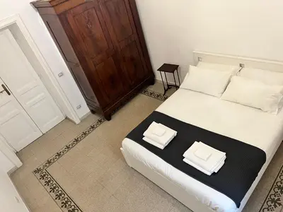 a bedroom with a bed with two white pillows on it at Gianicolo Hill Apartment in Rome