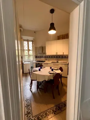 a kitchen with a table and chairs in a room at Gianicolo Hill Apartment in Rome