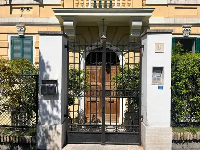 an entrance to a house with a black gate at Gianicolo Hill Apartment in Rome