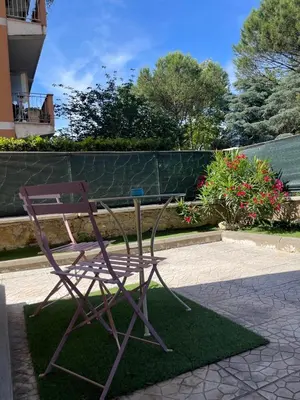 a sculpture of a chair sitting on top of grass at Casa Cycas in Rome