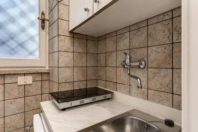 a kitchen with a sink and a faucet at Residenza Ripetta in Rome