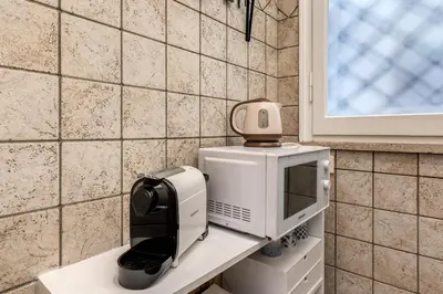 a coffee maker on a counter next to a microwave at Residenza Ripetta in Rome