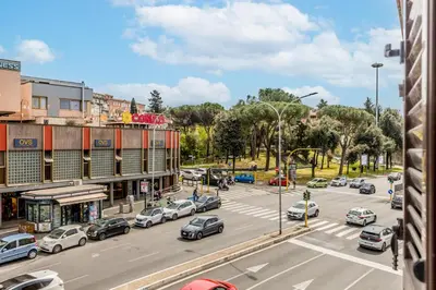 a busy city street with cars parked on the road at Otium Urbano in Rome