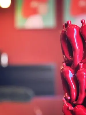 a close up of a red object in front of a red wall at Otium Urbano in Rome