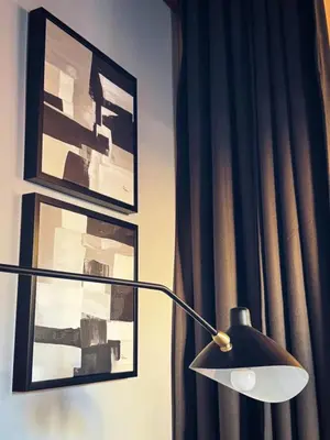 a lamp in a room with pictures on the wall at Otium Urbano in Rome
