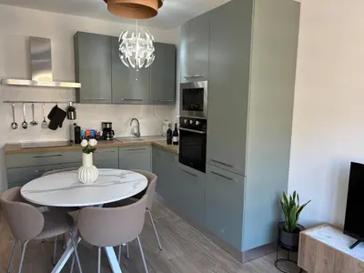 a kitchen with a small white table and chairs at Aulo Plauzio Apartment in Rome