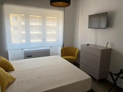 a bedroom with a bed and a dresser and a window at Aulo Plauzio Apartment in Rome