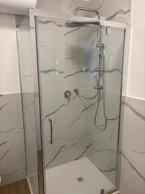 a shower in a bathroom with a glass door at Aulo Plauzio Apartment in Rome