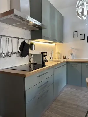 a kitchen with blue cabinets and a counter top at Aulo Plauzio Apartment in Rome