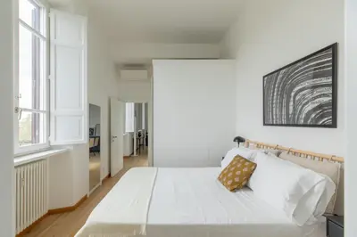 a bedroom with white walls and a bed with white sheets at iFlat Contemporary Elegant Skyline in Rome in Rome