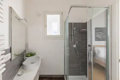 a bathroom with a shower and a toilet and a sink at iFlat Contemporary Elegant Skyline in Rome in Rome