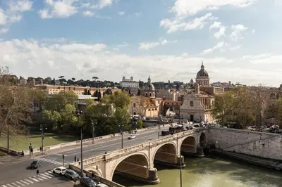 a bridge over a river in a city with cars at iFlat Bright & Modern Living with Panoramic View in Rome