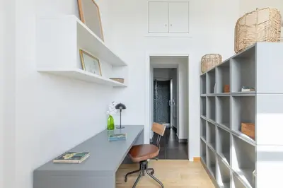 a home office with a desk and shelves at iFlat Bright & Modern Living with Panoramic View in Rome