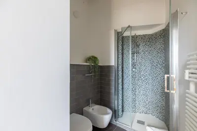 a bathroom with a shower and a toilet and a sink at iFlat Bright & Modern Living with Panoramic View in Rome