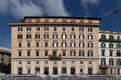 a large building with cars parked in front of it at iFlat Bright & Modern Living with Panoramic View in Rome