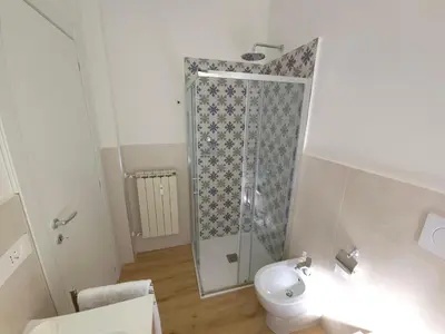 a bathroom with a shower with a toilet and a sink at San Paolo Charme Apartment in Rome