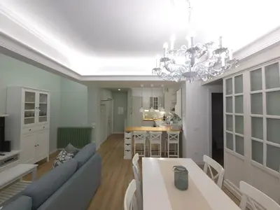 a living room with a table and a chandelier at San Paolo Charme Apartment in Rome