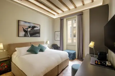 a hotel room with a bed and a window at BeSecret Belsiana in Rome